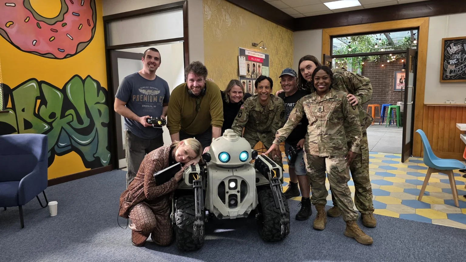 Mechatrons FX with cast, producers and director on Going Dutch beside the practical robot